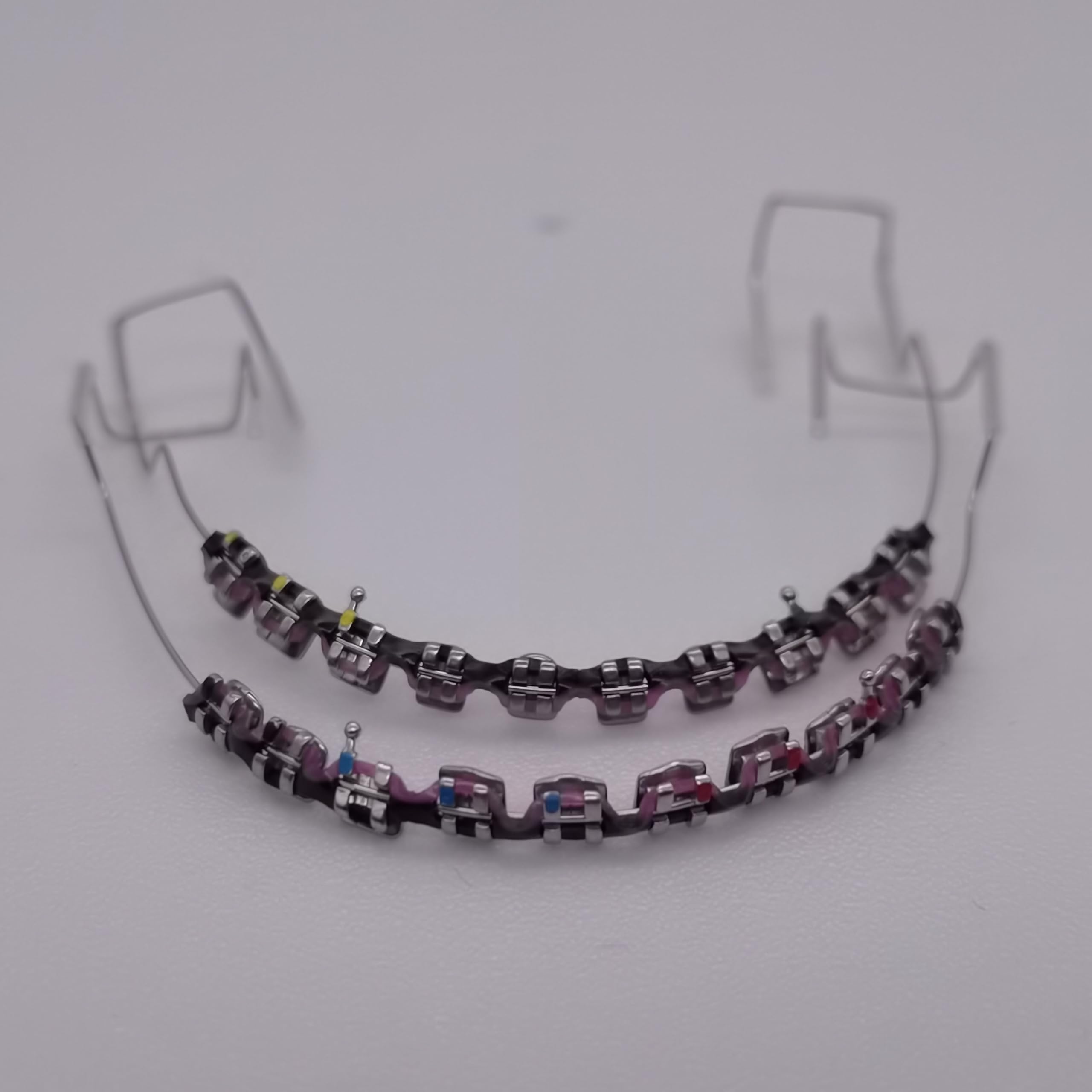 Metal brackets and wire with colorful power chains for dental practice