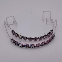 Metal brackets and wire with colorful power chains for dental practice