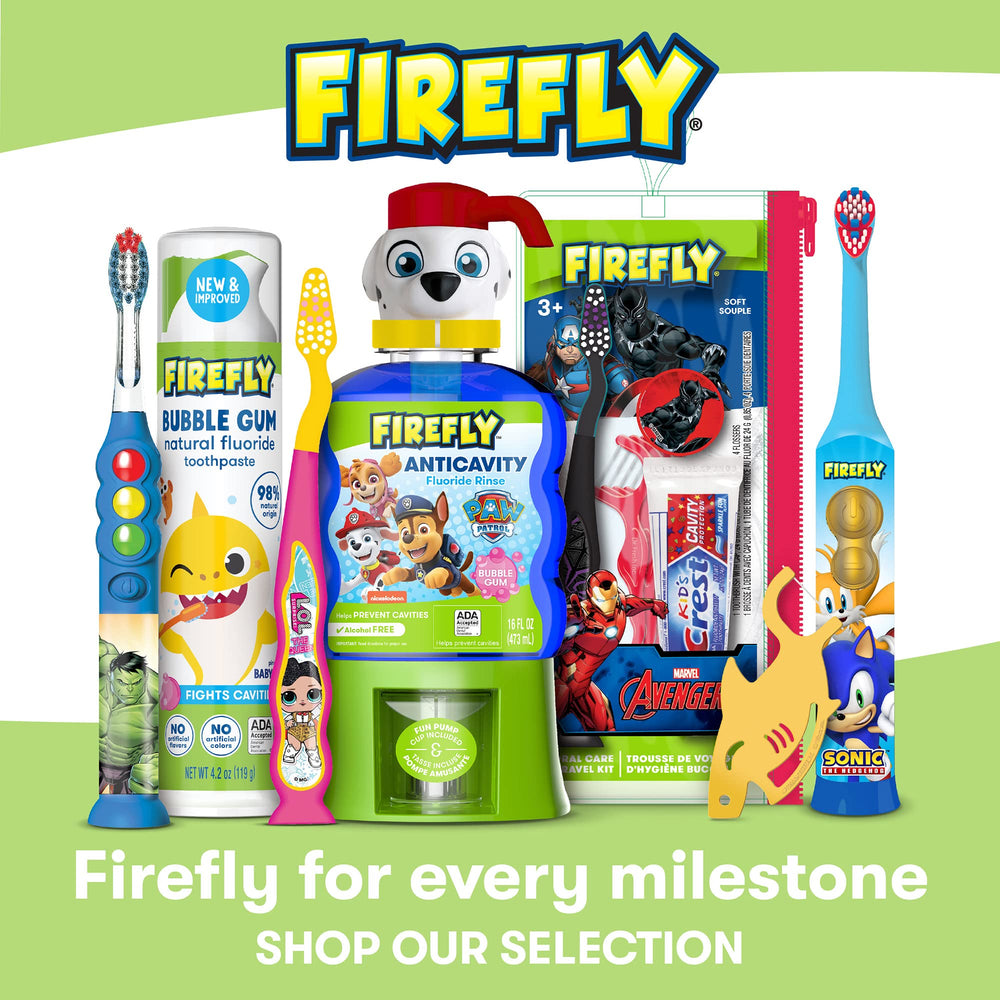 Baby smiling while brushing with Firefly kit