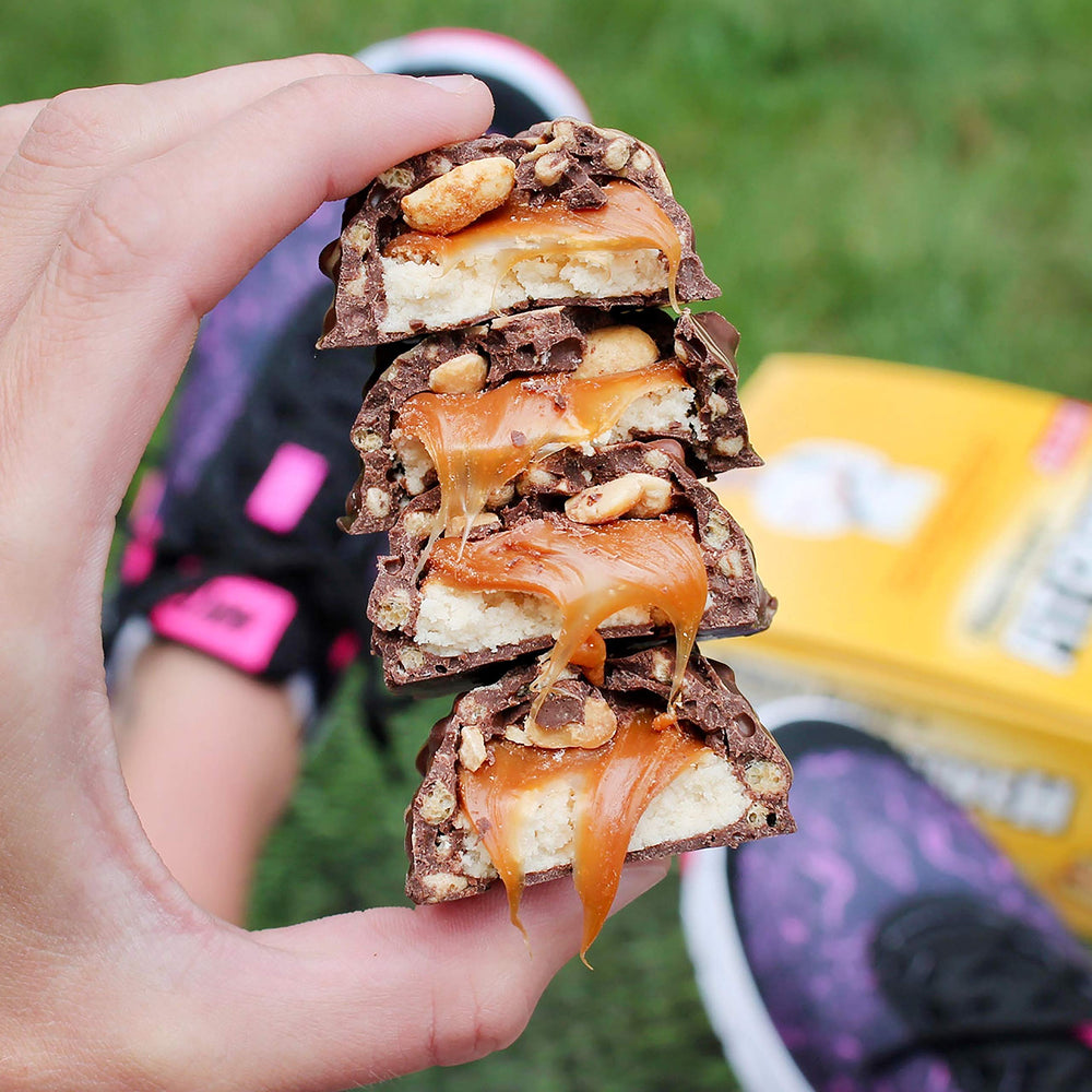 FITCRUNCH snack bar in hand ready for travel or gym bag use.