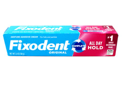 Denture adhesive cream being applied for secure fit