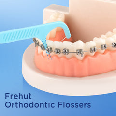 Close-up of braces floss picks showing floss between braces