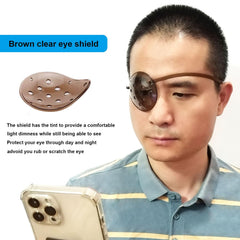 Dark color eye shield with adjustable strap for nighttime use
