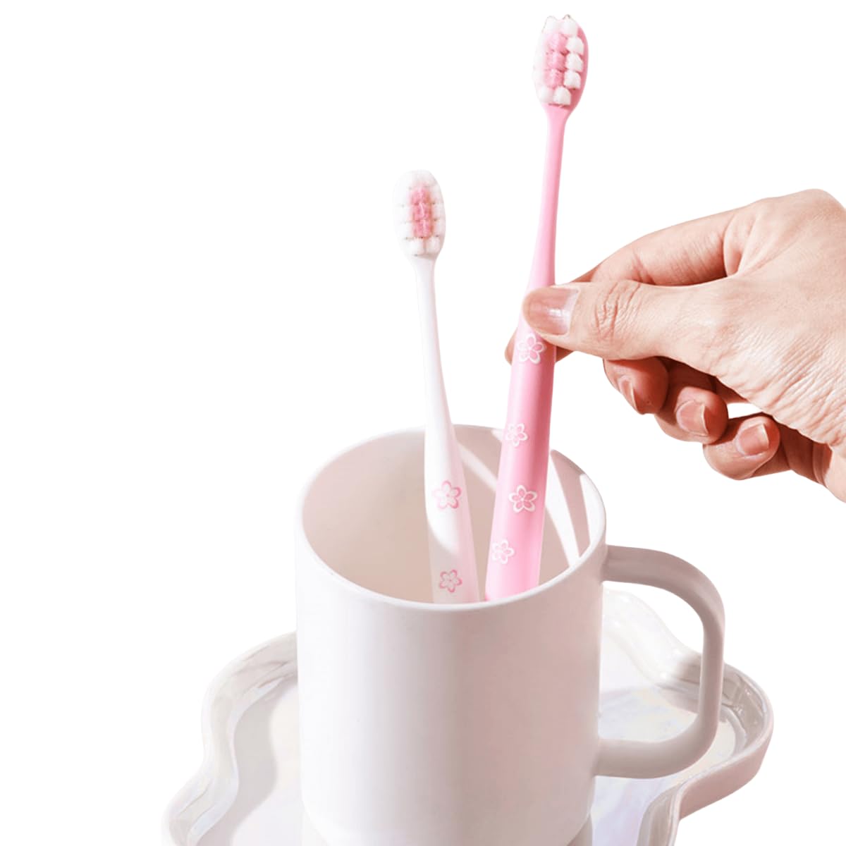 Set of pink toothbrushes with cherry blossom motif