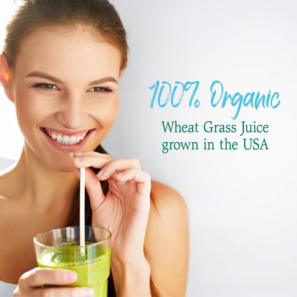 Wheat grass powder scoop poured into a glass of juice