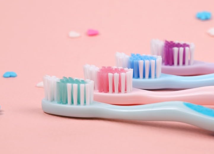 Set of colorful character toothbrushes arranged on a white background