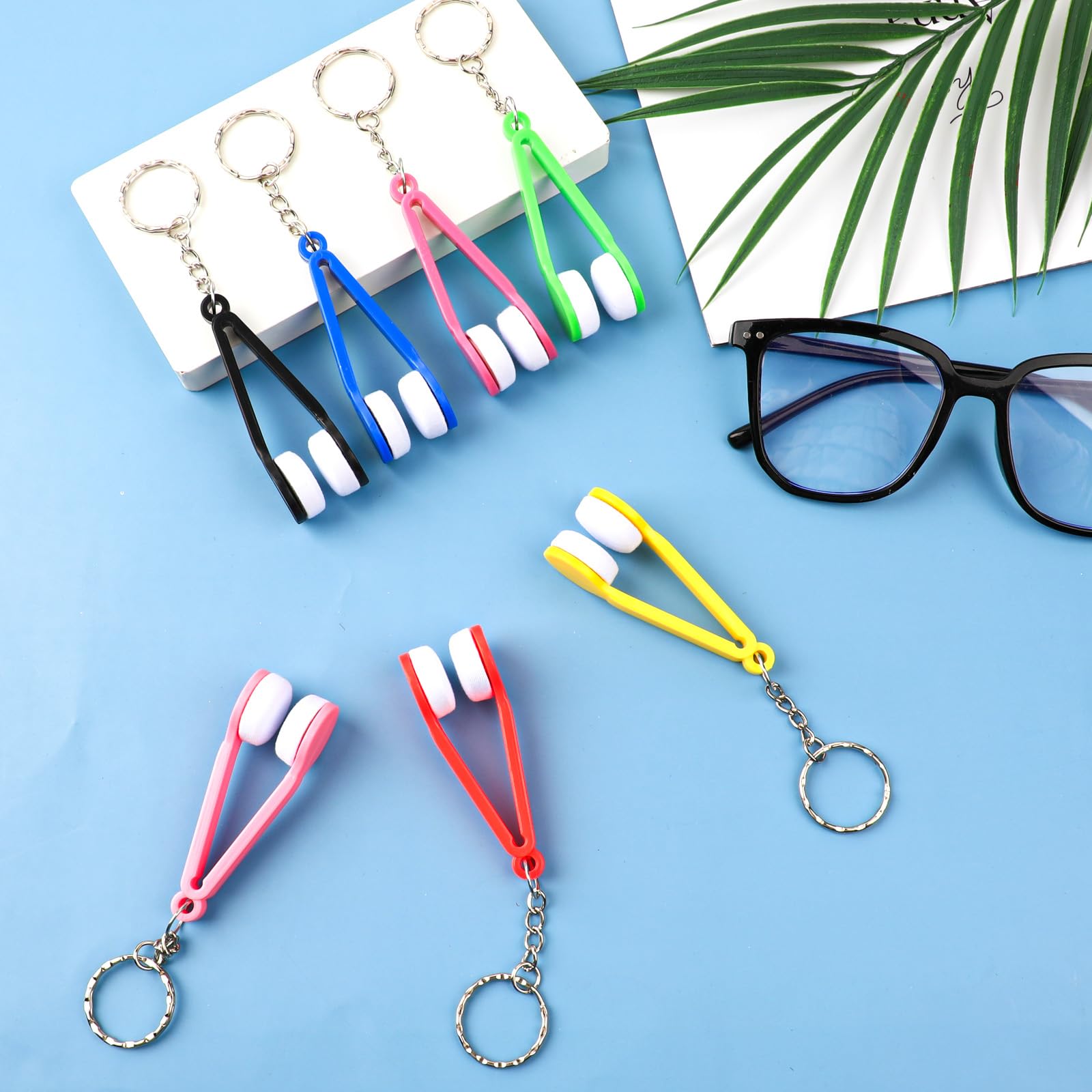 Pink tweezers-shaped glasses cleaning clip with keychain