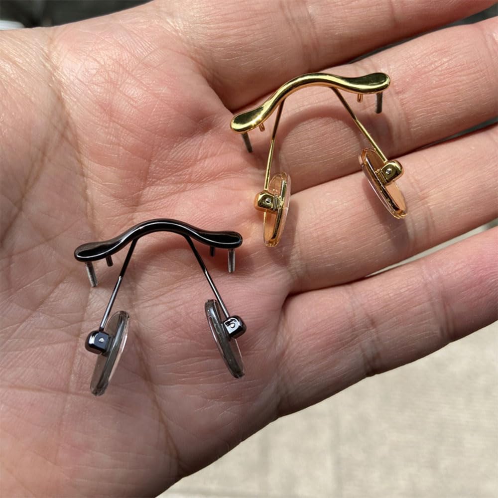 Glasses with nose pad arm and pad installed