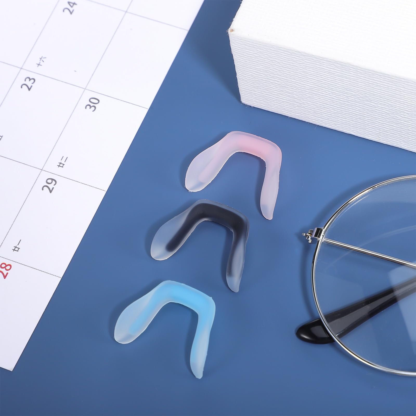 Eyewear with replacement nose pads on table
