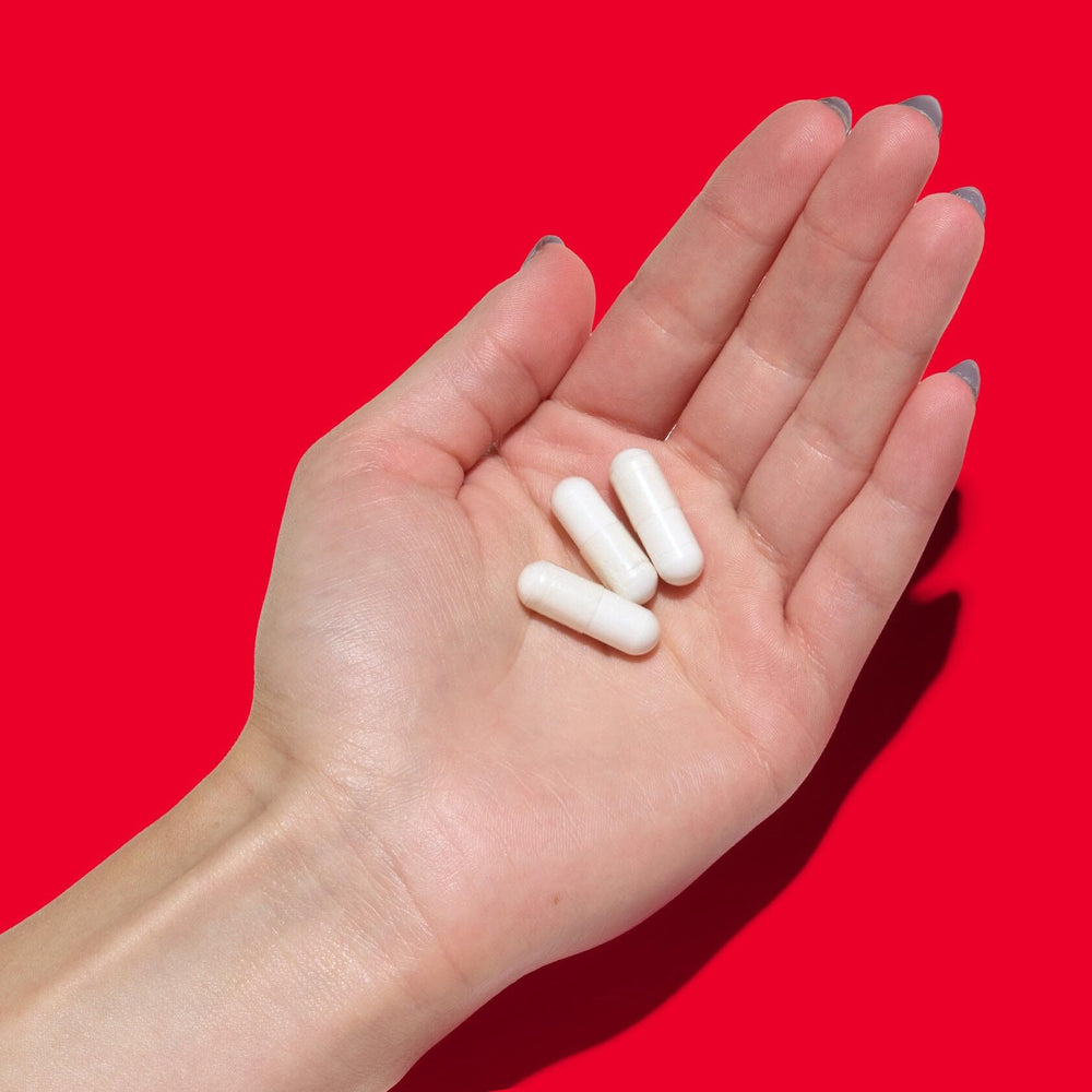 GNC Super Magnesium 400mg bottle on white background with 90 caplets