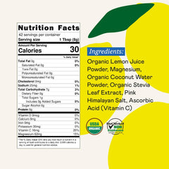 Powder scoop with lemonade-flavored electrolyte drink mix and glass of water