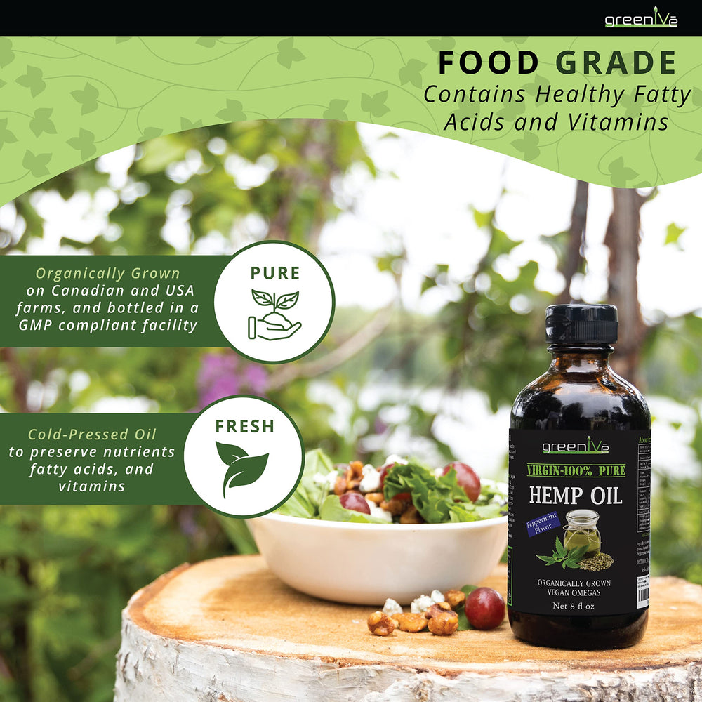 Hemp oil being added to salad and spoonful ready to use