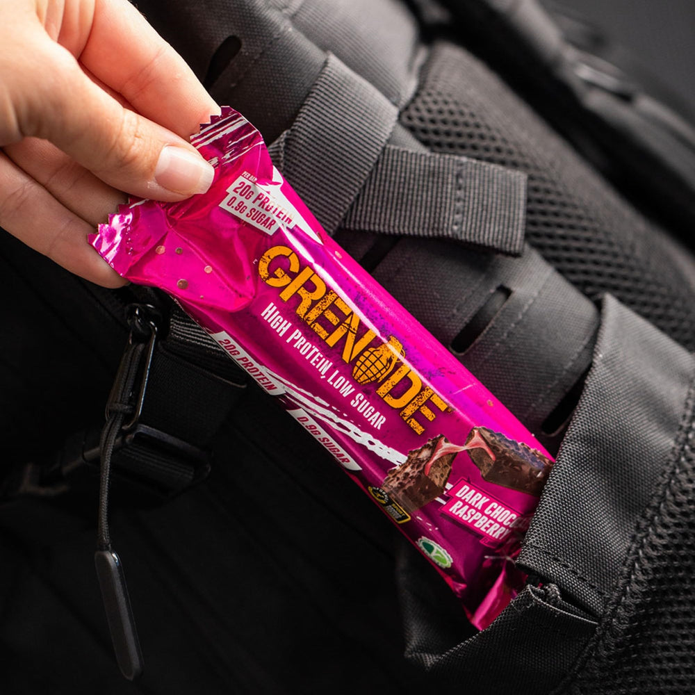 Grenade high-protein bar slice shows chocolate chunks and caramel.