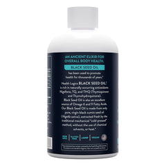 Dropper dispensing black seed oil into a spoon