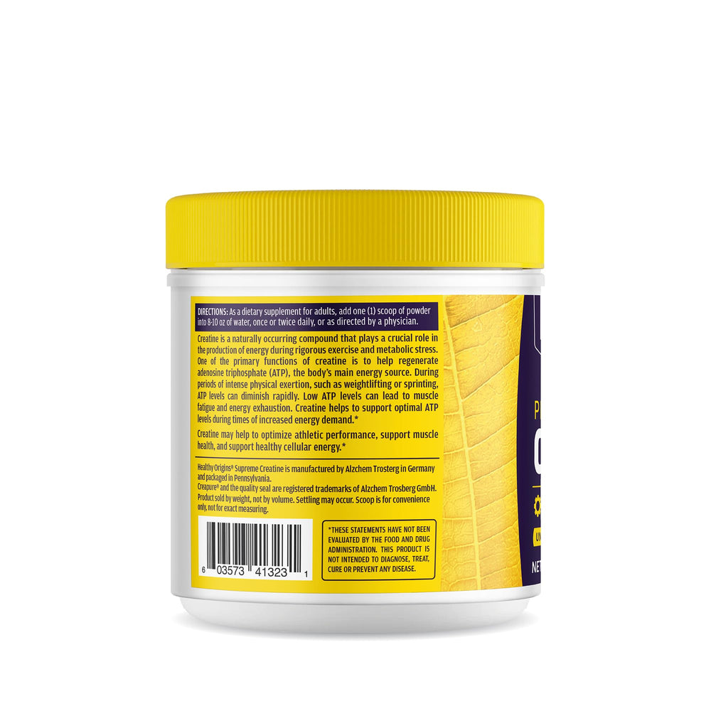 Creatine powder being added to a measuring scoop