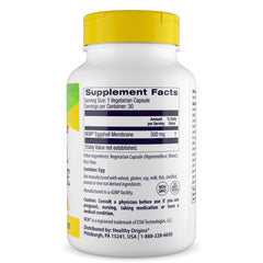 Close-up of yellow veggie capsules next to the bottle