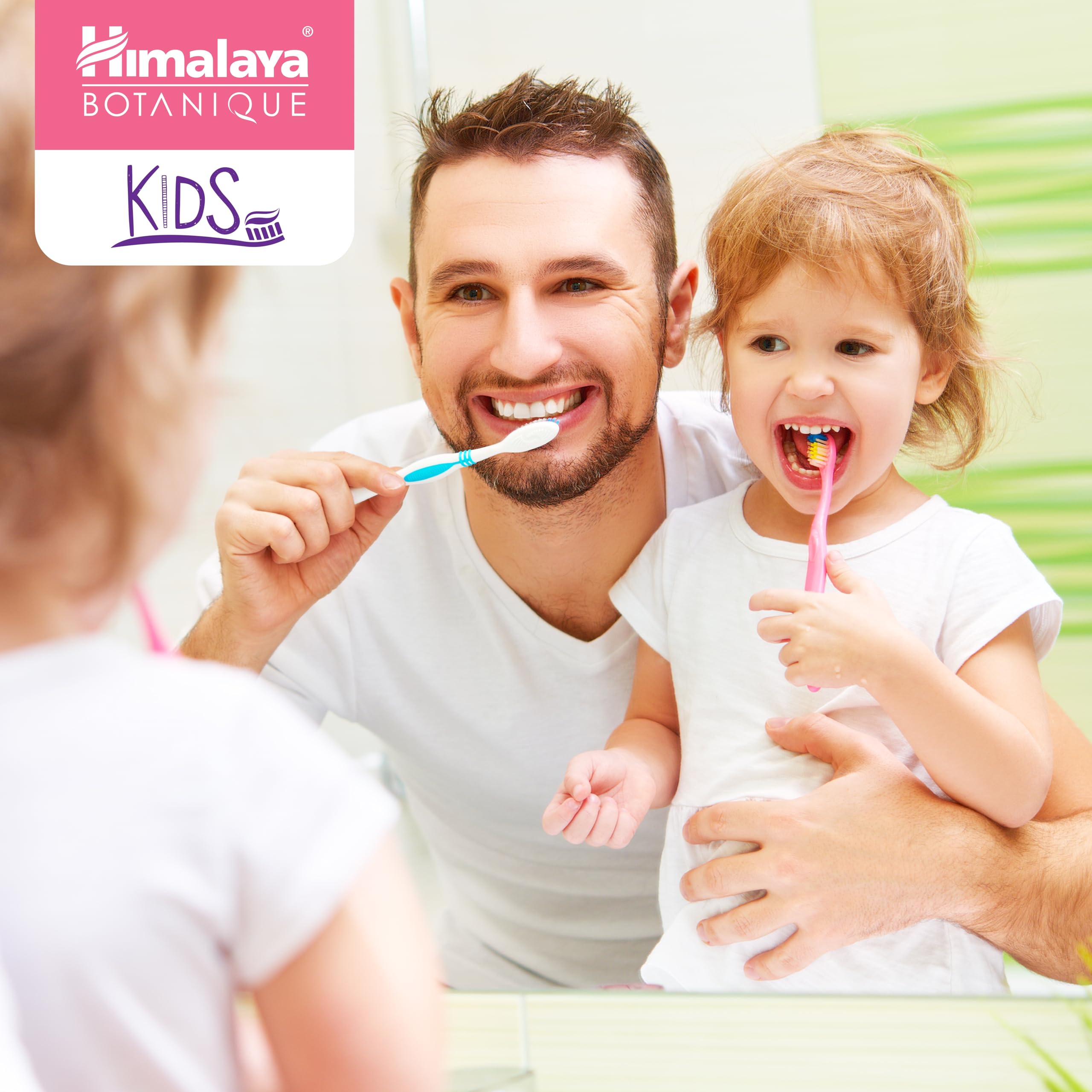 Child brushing teeth with Himalaya Botanique toothpaste, smiling