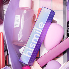 Person applying Glostik gloss to teeth