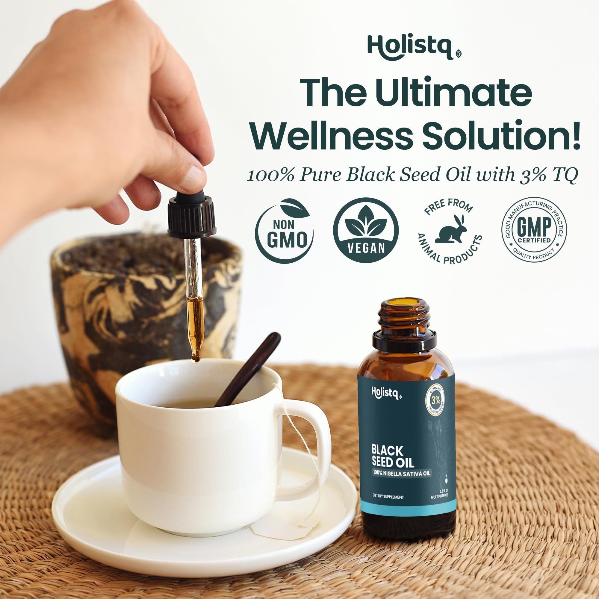 Pouring black seed oil from a glass dropper bottle