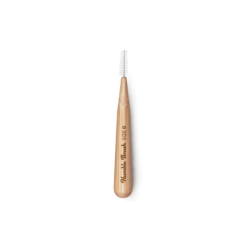 Close-up of The Humble Co Bamboo Interdental Brush showing bamboo handle and purple hue