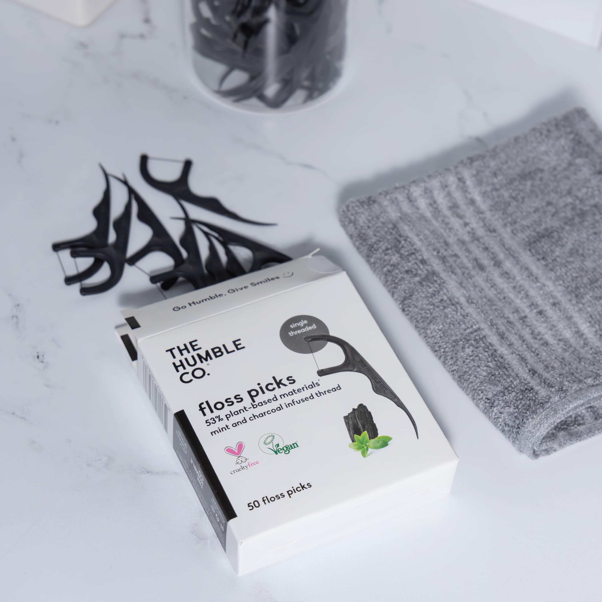 Gum health-focused floss picks in use