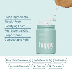 HUPPY toothpaste tablets stacked beside a strawberry