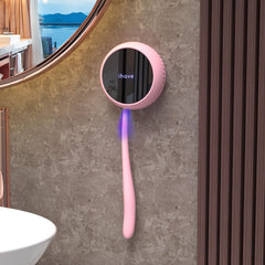 Pink iHave toothbrush sanitizer mounted on bathroom wall with magnetic bracket