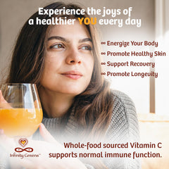 Scoop of Infinity-C Vitamin C Powder over a glass of water