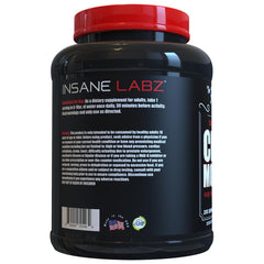 Serving scoop with creatine monohydrate powder beside a shaker