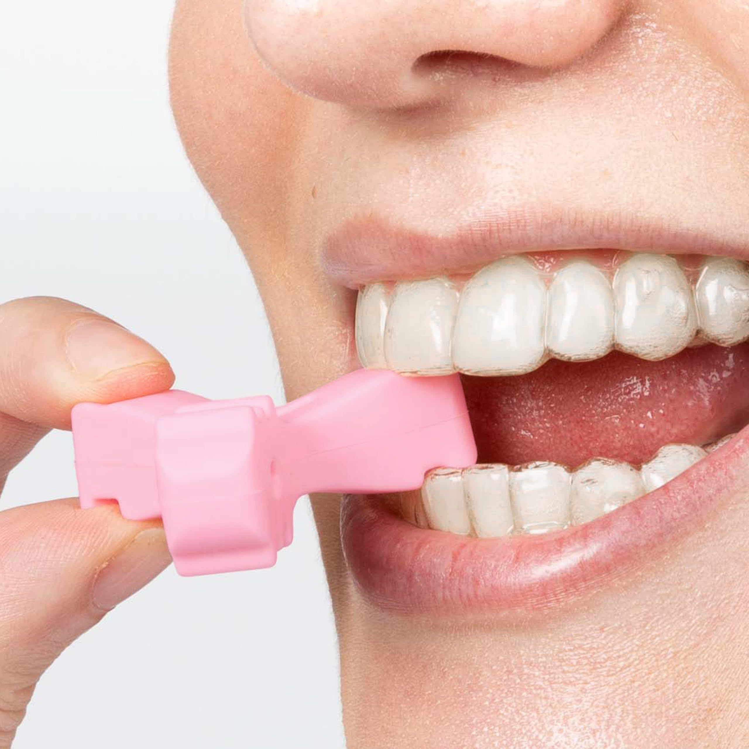 User biting chewies to seat clear aligners