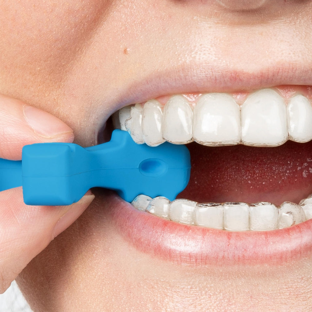 Pink three-arm Invisalign aligner seaters close-up