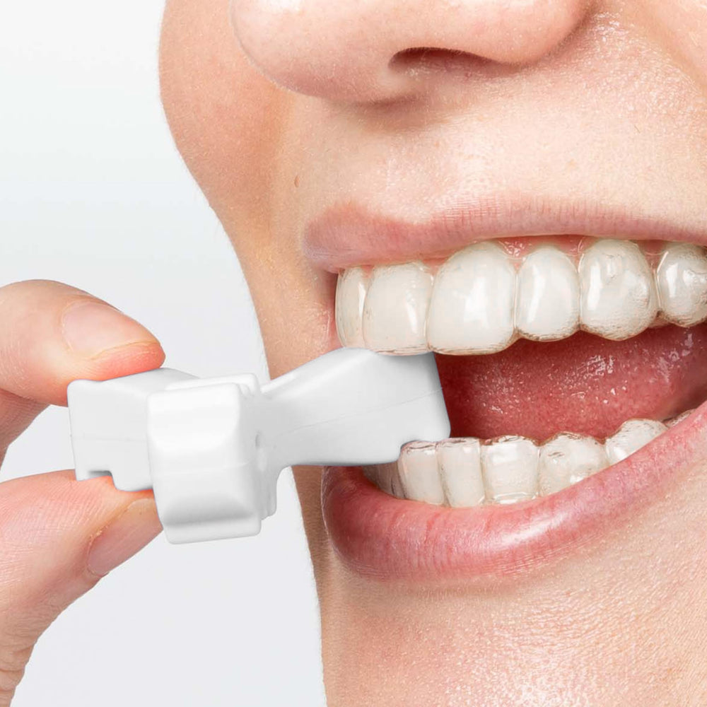 User bites down into the designated groove of the chewies while wearing aligners