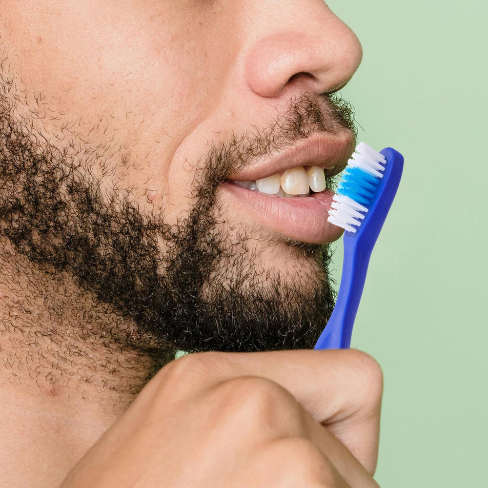 Close-up of 9cm mini toothbrush showing soft bristles
