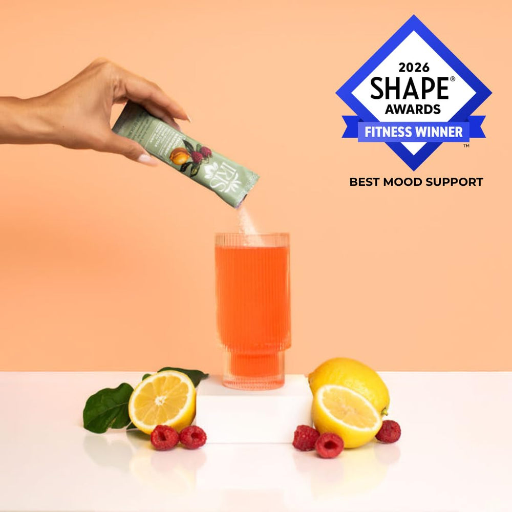 Iris single‑serve packet open next to glass to highlight portability