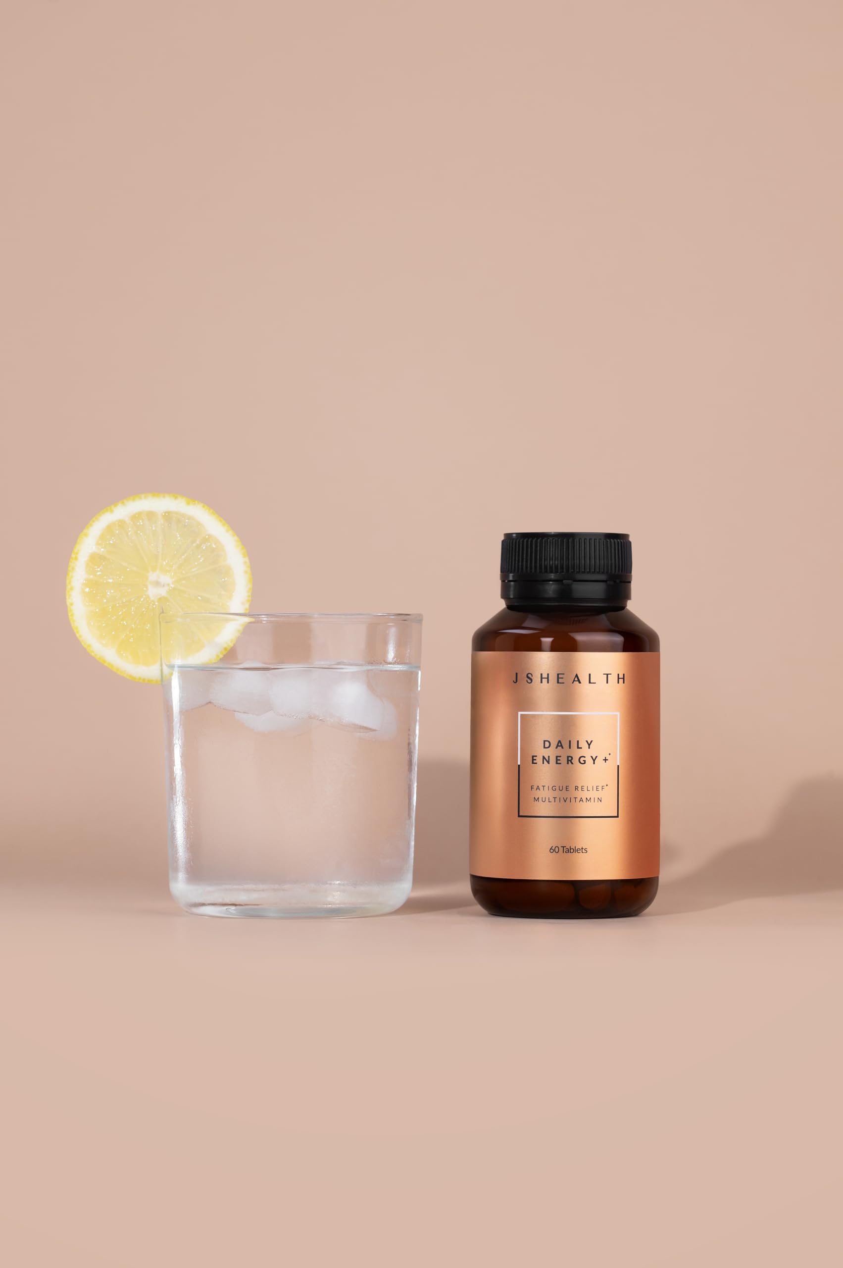 JSHealth Daily Energy Supplement pills closeup highlighting energy and focus benefits.