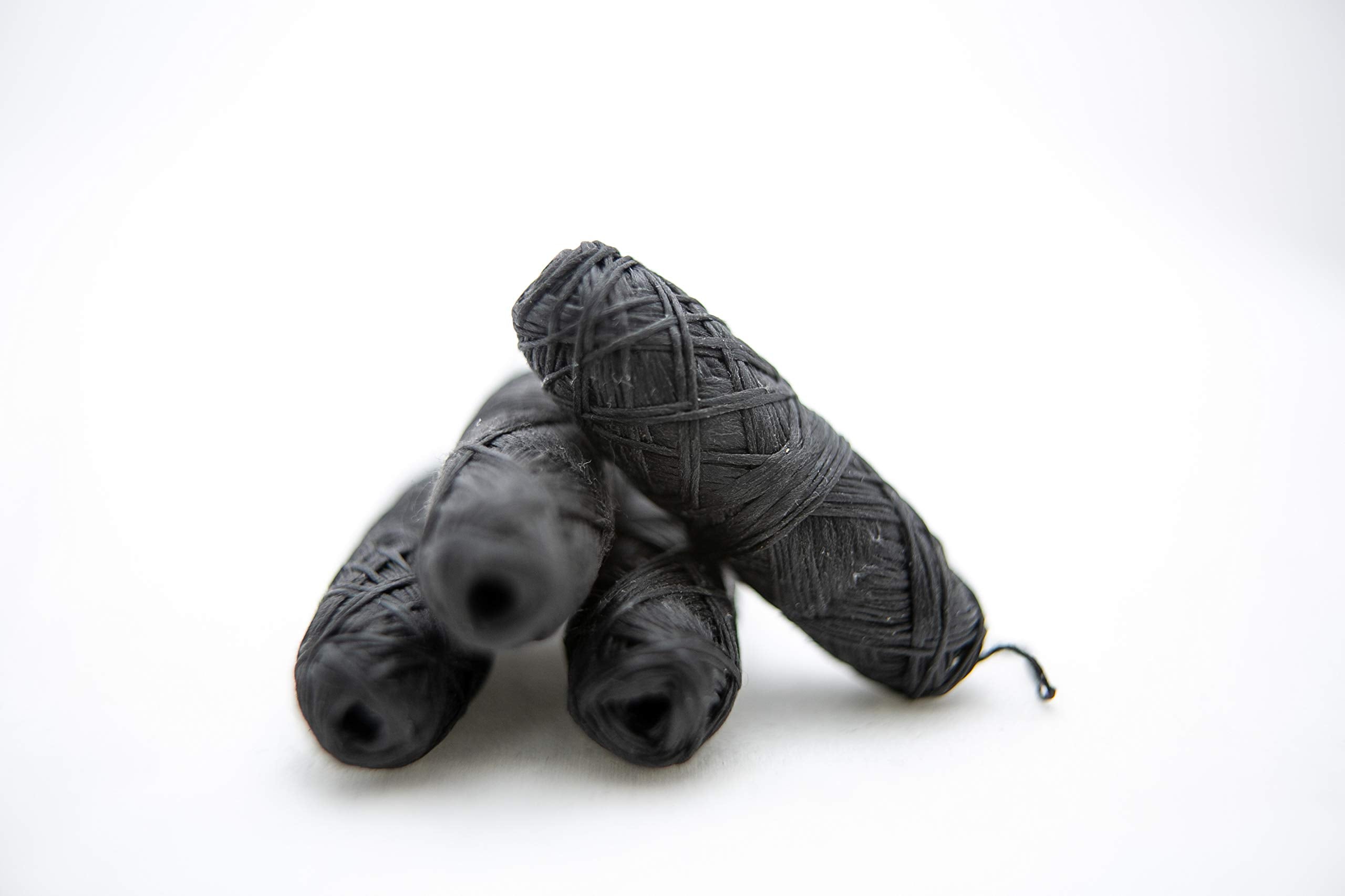 Close-up of bamboo charcoal floss texture with mint flavor