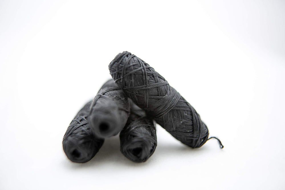 Close-up of bamboo charcoal floss texture with mint flavor