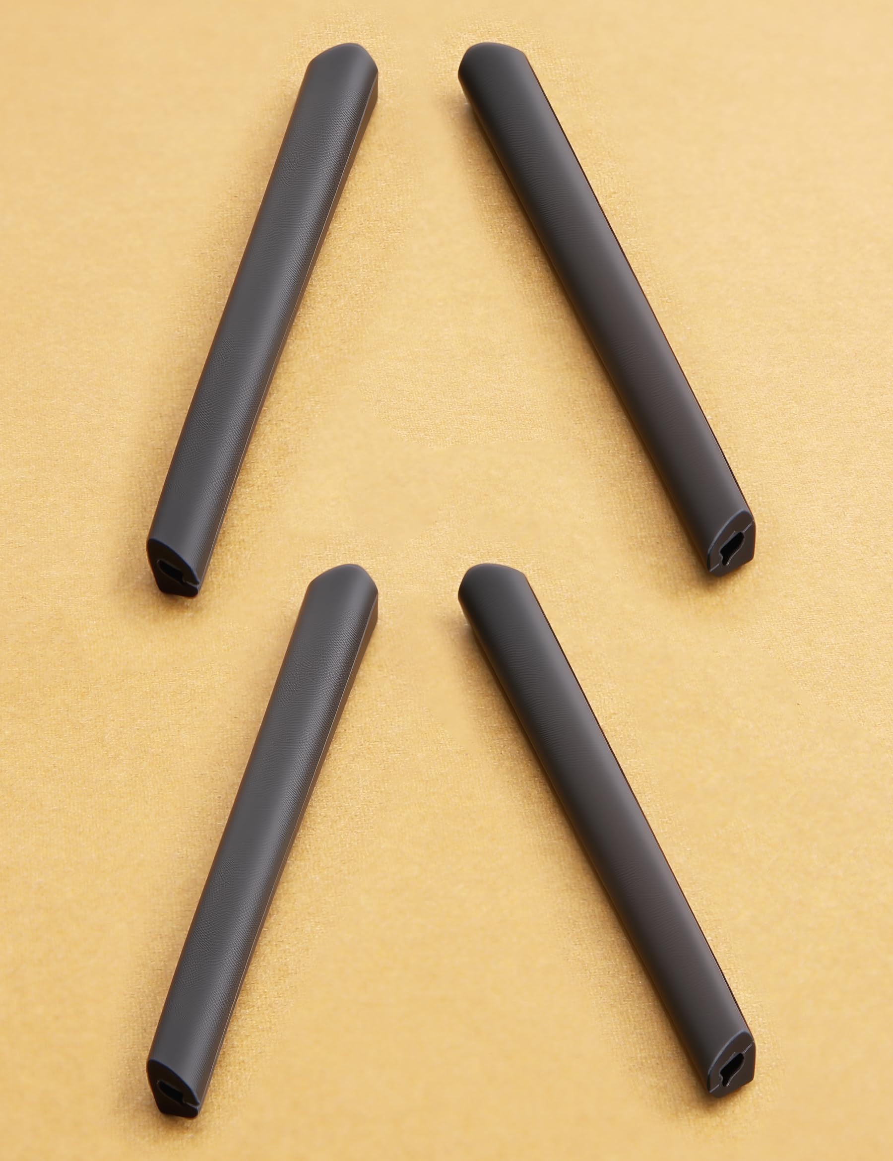 Two pairs of black silicone temple sleeves for active wear