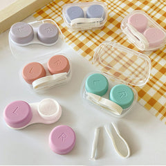 Portable slim contact lens case with secure snap-lock lid and transparent shell