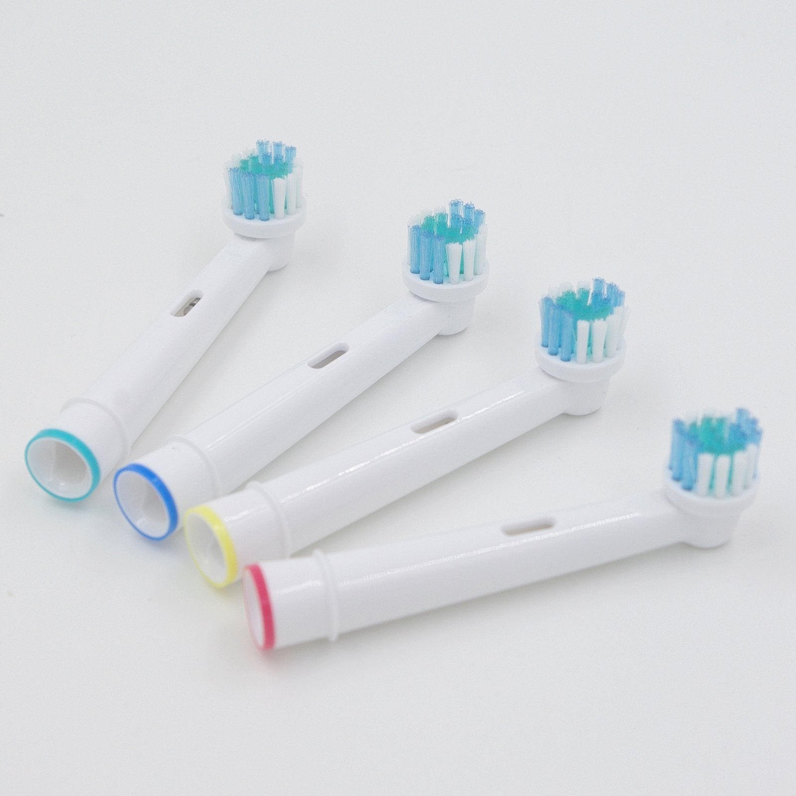 Soft bristle brush heads with color-coded rings for easy identification
