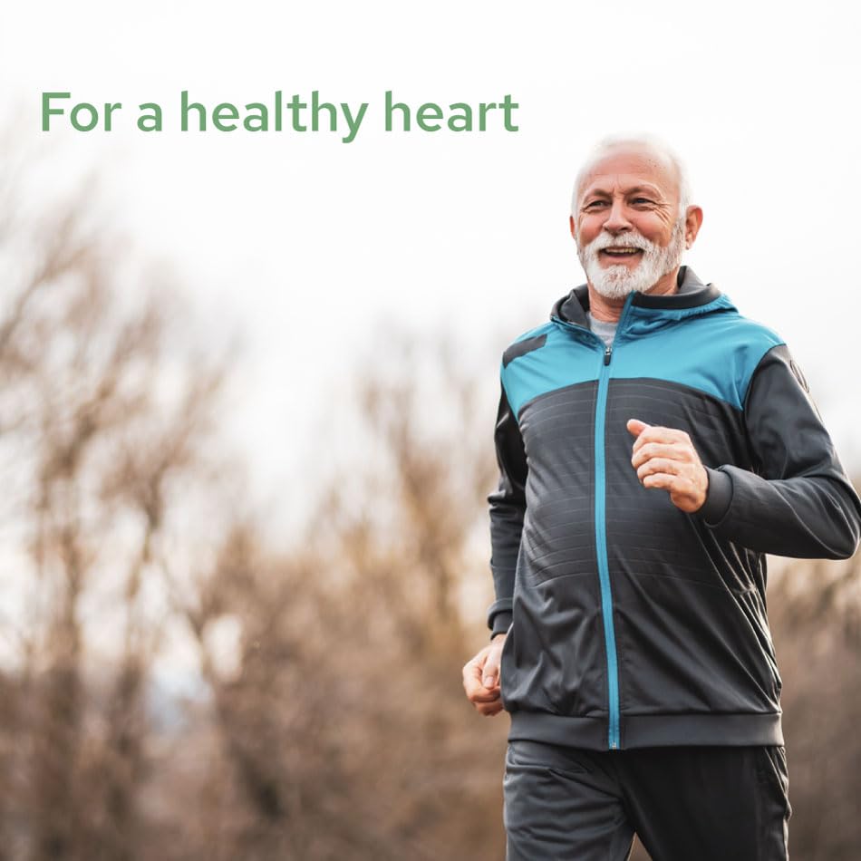 Person taking a magnesium citrate softgel with glass of water