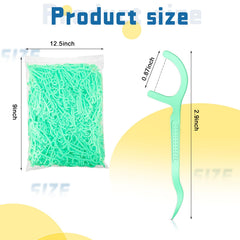 Close-up of green floss picks with mint flavor