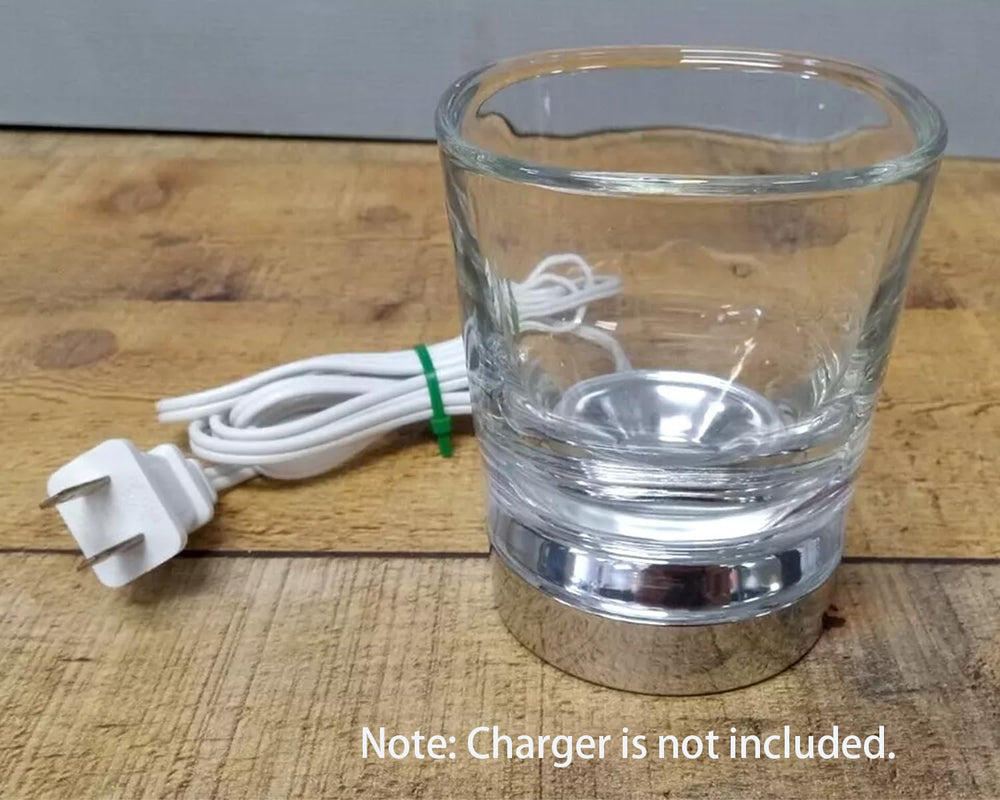 Open packaging showing glass cup, charging stand, and head covers