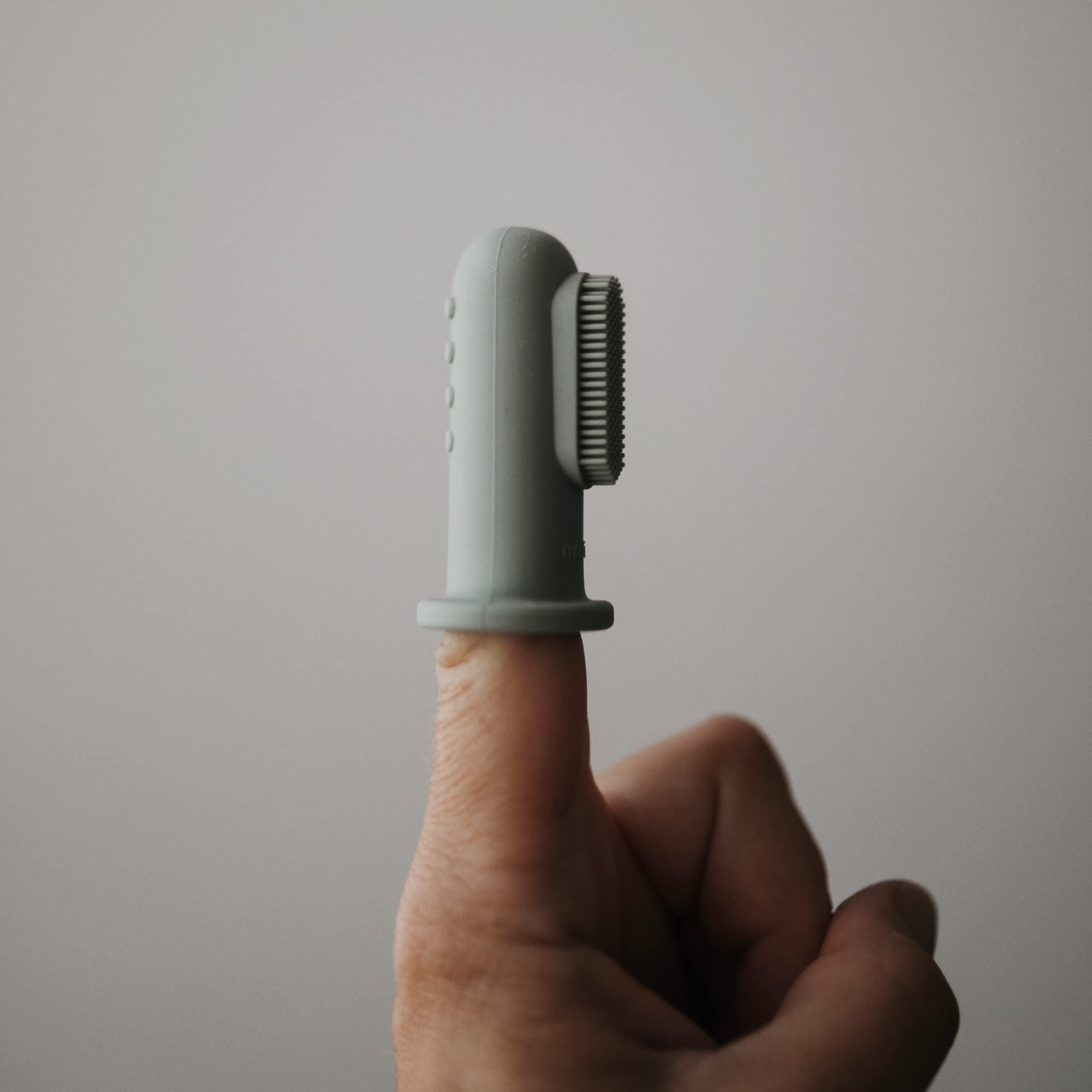 Close-up of silicone finger toothbrush on finger