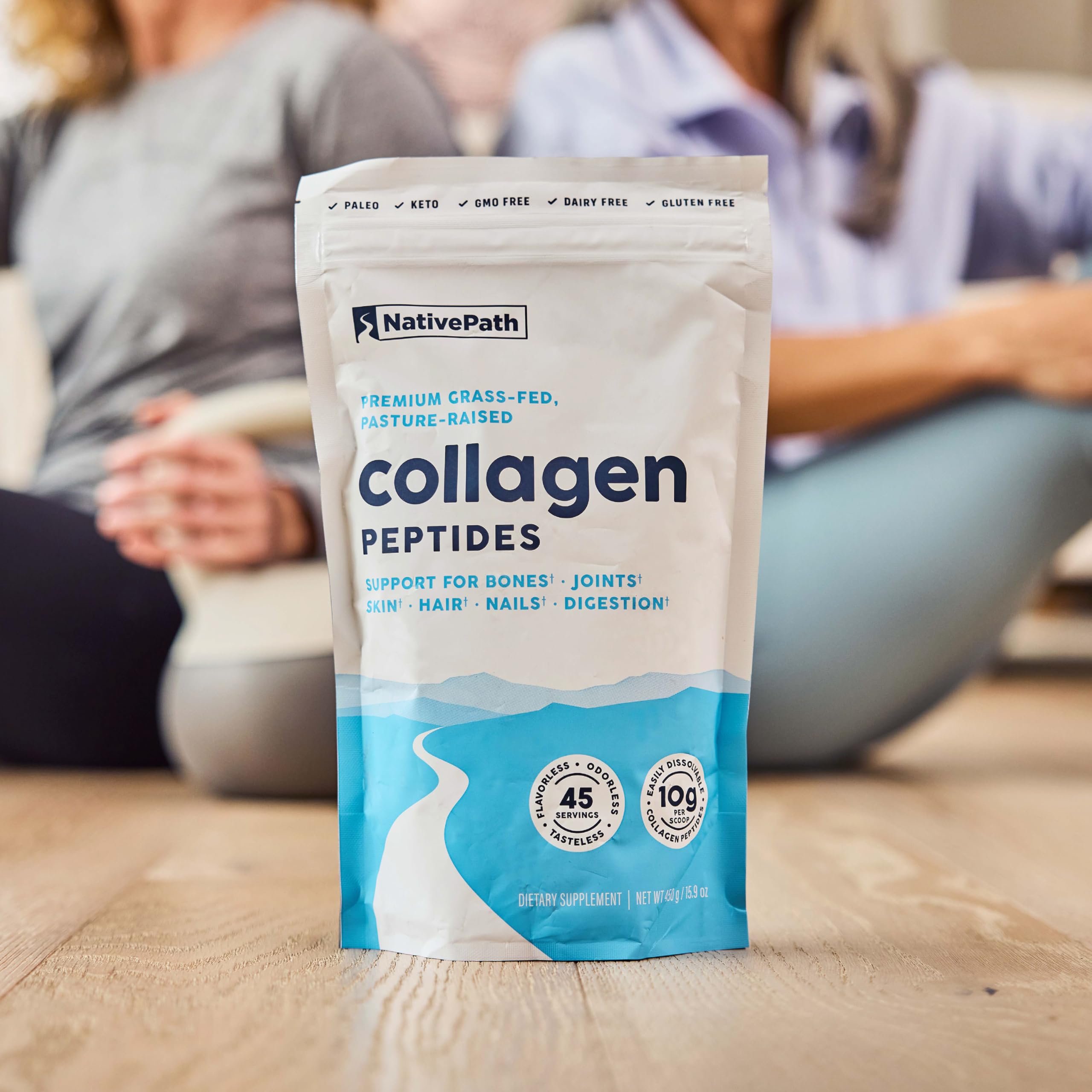 Collagen peptides container with scoop on kitchen counter