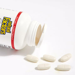 Capsules next to bottle on white background