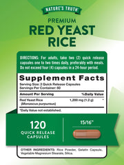 Close-up of red yeast rice capsules next to bottle
