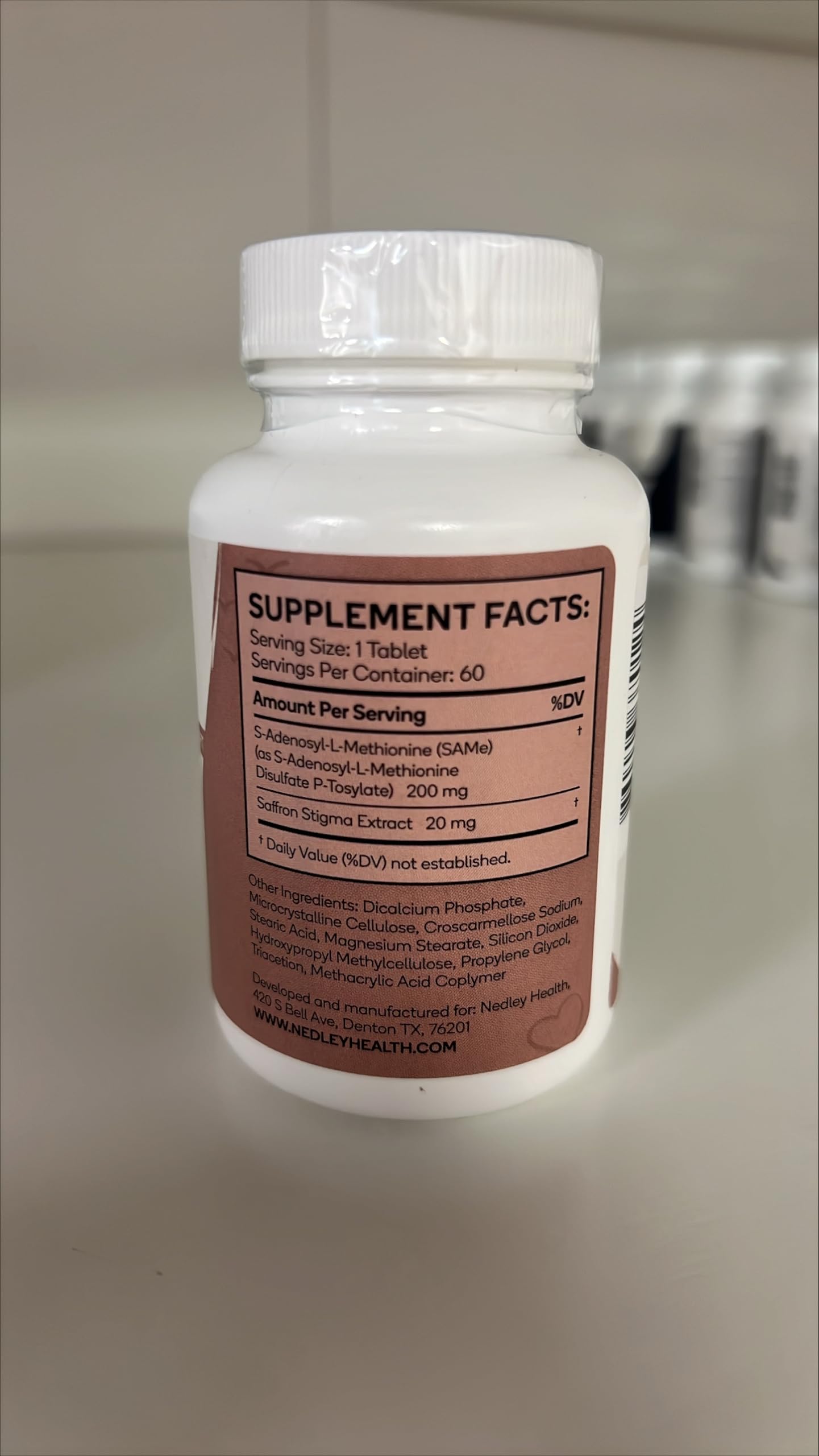 Flat lay of Nedley Health Mood with a glass of water