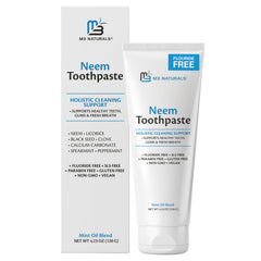 Toothpaste tube on bathroom counter with fresh mint leaves