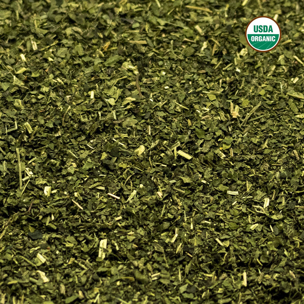 Brewing nettle tea in a cup showing milky tint